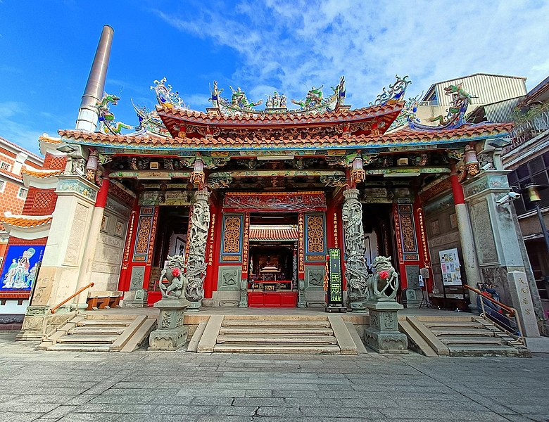 Grand Mazu Temple facade with ornate roof decorations and stone columns