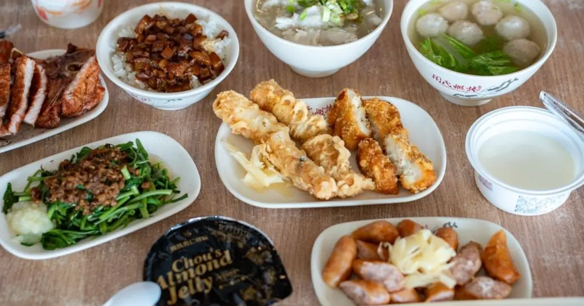 Several Tainan snacks served together, including shrimp rolls, rice, soups, and fried dishes